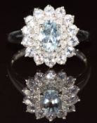 A 9k white gold ring set with an oval cut aquamarine, diamonds and morganite, 2.9g, size P
