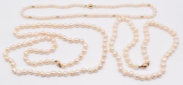 Three strands of cultured pearls with 14k gold clasps, 45 & 74cm