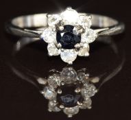 An 18ct white gold ring set with a sapphire surrounded by diamonds, 2.1g, size J