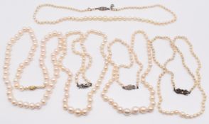 Five strands of cultured pearls, all with silver clasps, longest 44cm