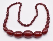 Cherry amber necklace made up of graduated oval beads, largest 21 x 30mm, smallest 7 x 10mm, 68g