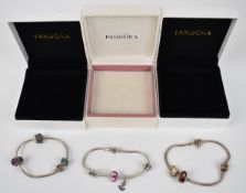 Three Pandora bracelets with nine charms including Christmas tree, stocking, anchor, 'Best Friends',