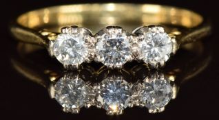 An 18ct gold ring set with three diamonds, the total diamond weight approximately 0.45ct,  3.1g,