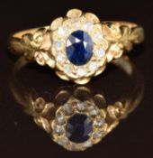 An 18ct gold ring set with an oval sapphire surrounded by rose cut diamonds, 3.3g, size N