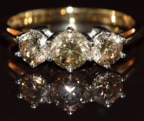 An 18k gold ring set with three champagne diamonds of approximately 0.58, 0.35 & 0.35ct, 3.2g,