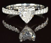 A platinum ring set with a 1.01ct heart cut diamond and with diamond encrusted shoulders, with GIA