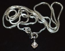 An 18ct white gold pendant set with a diamond of approximately 0.16ct on 9ct white gold chain, 2.8g,