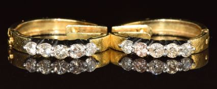 A pair of 18ct gold earrings each set with five round cut diamonds (total diamond weight