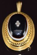 A 14k gold pendant / brooch set with a banded agate cabochon set with four old cut diamonds to the