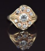 A 14k gold ring set with nine diamonds, the largest approximately 0.7ct, 5.4g, size P