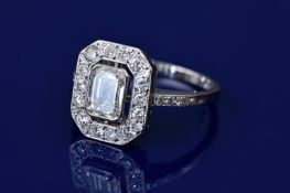 An 18ct white gold ring set with a 1ct emerald cut diamond surrounded by 14 round cut diamonds, each