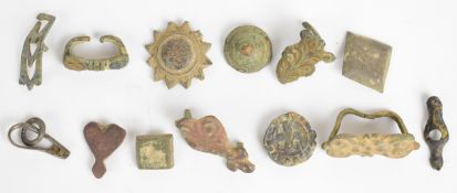 Twelve metal detecting bridle/ leather decoration mounts, most with location of find on bag