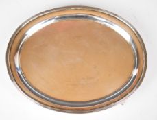 Carrington & Co. George V hallmarked silver oval card tray or salver, raised on four feet,