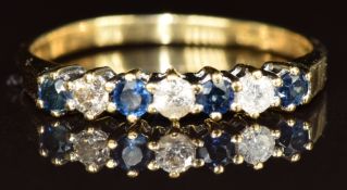 An 18ct gold ring set with alternating sapphires and diamonds, 2.2g, size P