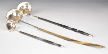 Three Georgian silver whalebone handled toddy ladles, the largest unmarked but with crest to bowl,