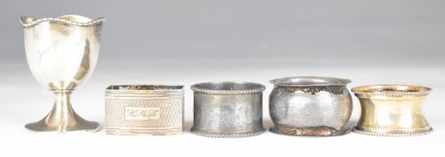 Four various hallmarked silver napkin rings including an engine turned example, together with a