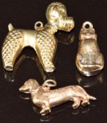 Three 9ct gold charms including two dogs and a cat, 3.3g