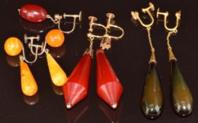 Three pairs of 9ct gold earrings set with amber and faux amber and one single 9ct gold earring set