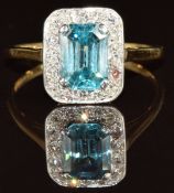 An 18ct gold ring set with an emerald cut zircon surrounded by diamonds, 3.2g, size R