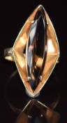 A 9ct gold 1970's ring set with a marquise cut smoky quartz, 5.6g, size Q