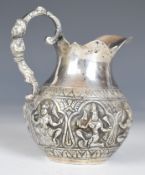 Indian or Burmese silver jug with embossed decoration of deities, height 10cm, weight 98g