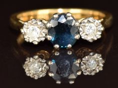 An 18ct gold ring set with an oval cut sapphire and two diamonds, 4g, size M