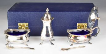 Cased Elizabeth II hallmarked silver three piece cruet set with blue glass liners, Sheffield 1989,