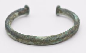 Celtic bronze bangle / tort with geometric incised decoration, diameter 7.5cm
