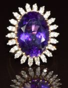 A 14k gold ring set with an oval cut amethyst of approximately 11ct surrounded by diamonds, 9.1g,