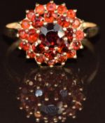 A 9ct gold ring set with a cluster of garnets, 3.1g, size R