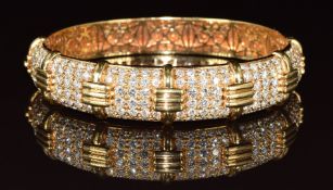 An 18k gold bangle set with 156 round cut diamonds totalling approximately 5.5ct in six panels, 5.