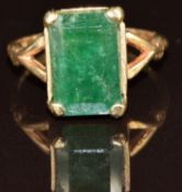 A 9ct gold ring set with an emerald cut emerald, 4.3g, size P