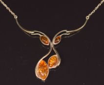 A 9ct gold necklace set with pressed amber cabochons, 4.3g, 35cm