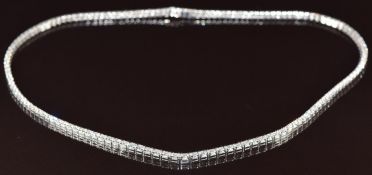 An 18ct white gold necklace set with 150 graduated round brilliant cut diamonds, the total diamond