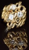 An 18k gold ring set with three diamonds, each approximately 0.25ct, in an abstract setting, 8.2g,
