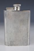 Art Deco hallmarked silver hip flask of curved form, with engine turned decoration and hinged