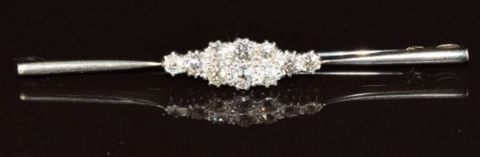A 9ct white gold brooch set with old cut diamonds in a platinum setting, the total diamond weight