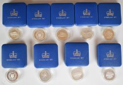 Nine cased 1977 Silver Jubilee crowns in original boxes comprising two standard examples, two