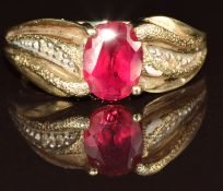 A 9ct gold ring set with an oval cut synthetic ruby and diamonds, 3.8g, size O