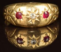 A c1900 18ct gold ring set with a ruby and two diamonds in star settings, 3.1g, size Q