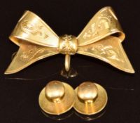 A 9ct gold bow brooch (3.4g) and two 18ct gold studs (2.9g)