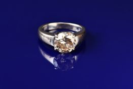 An 18ct white gold ring set with a 4.2ct round brilliant cut fancy yellowish brown diamond, with