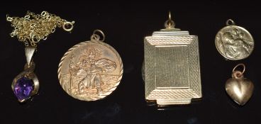 A 9ct gold locket with engine turned decoration, two 9ct gold St Christophers, 9ct gold pendant