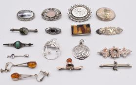A collection of silver brooches including Victorian with applied gold horseshoe and floral
