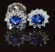 A pair of 18k white gold earrings each set with an oval cut sapphire of approximately 0.5ct