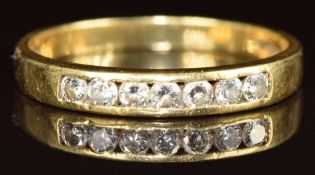 An 18ct gold ring set with seven diamonds, 2.6g, size O