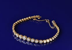 An 18ct gold bracelet set with 38 graduated round brilliant cut diamonds, largest diamond