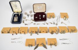 Twenty five pairs of silver earrings, silver perfume bottle and two silver studs set with mother