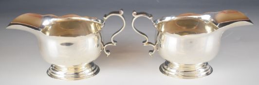 Pair of George V hallmarked silver large gravy or sauce boats with shaped edges, raised on footed