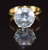 An 18ct gold ring set with a round cut white sapphire of approximately 4ct, 3.7g, size H